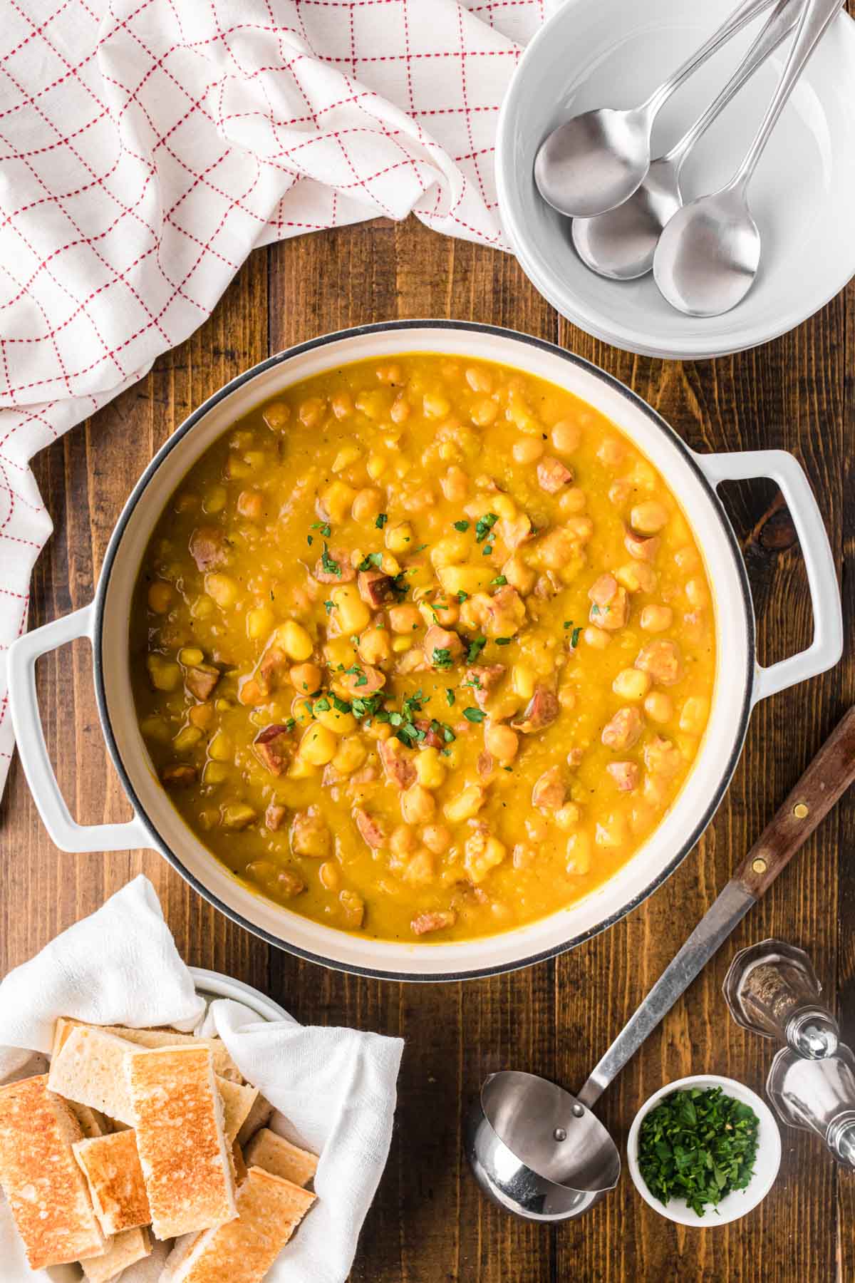 A white soup pot of garbanzo bean soup.