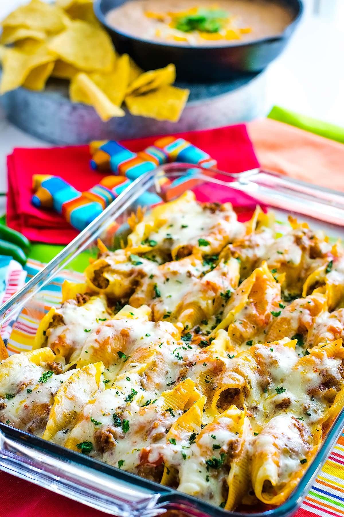 Mexican stuffed shells topped with melted pepperjack cheese in a casserole dish