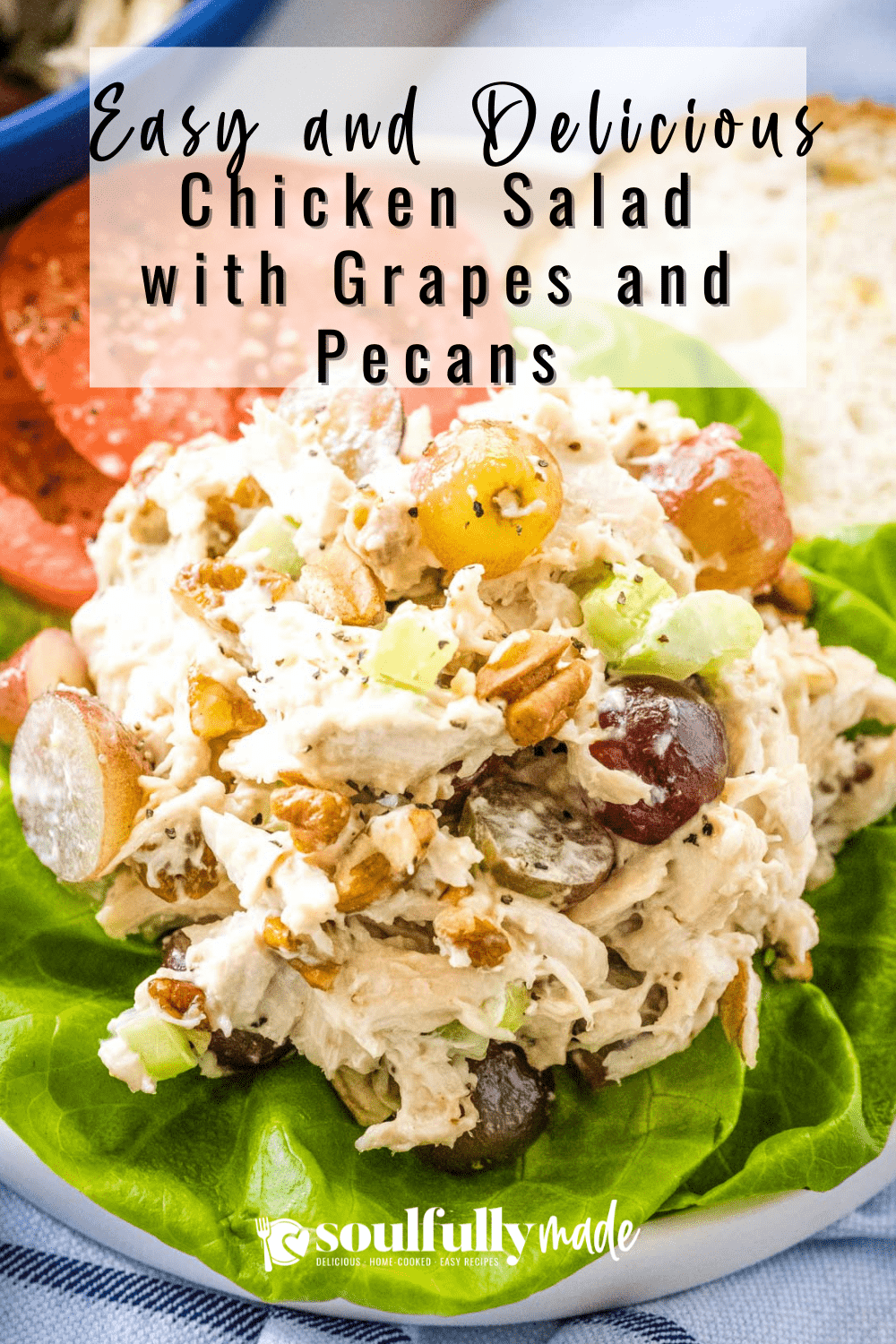 Chicken Salad with Grapes and Pecans on a bed of lettuce with a bun and tomatoes