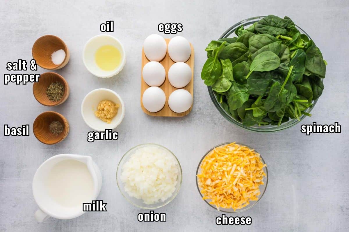 Labeled ingredients needed to make a crustless spinach quiche recipe.