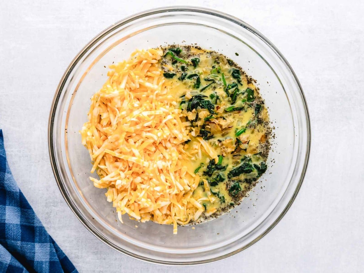 Shredded cheese and veggies added to egg mixture.