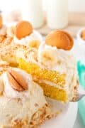 Banana pudding cake is featured in an image only pin with a slice being lifted out on a spatula.