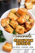 Homemade Crouton Recipe image of the buttery croutons in a white bowl overhead shot.