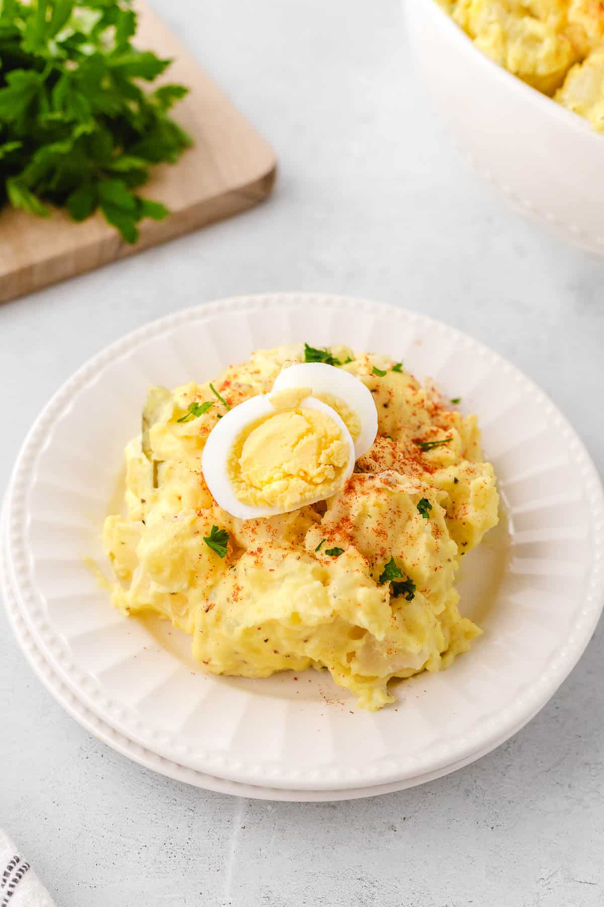 A white plate filled with potato salad.