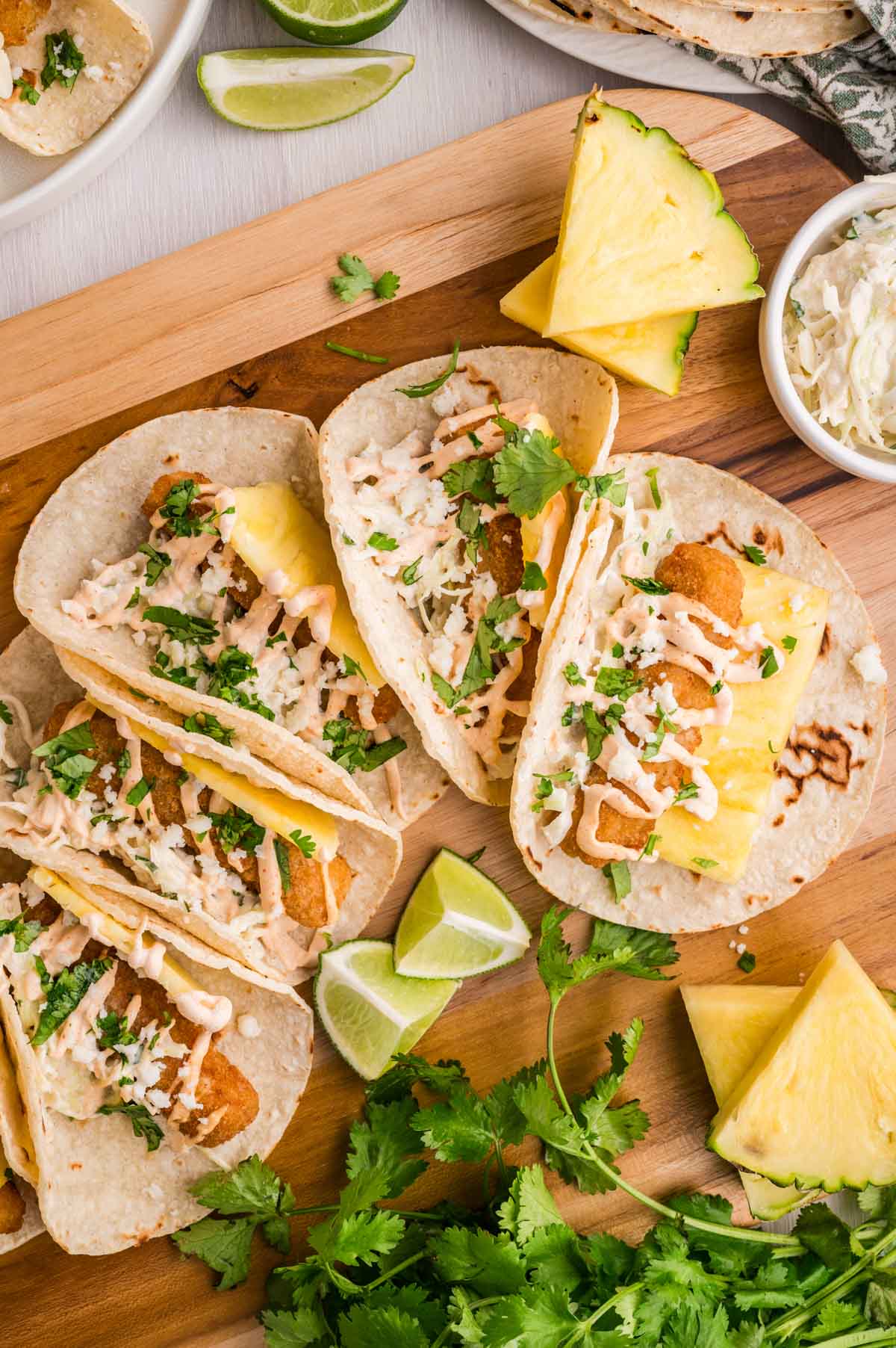 Easy fish stick tacos set on a wooden serving board.