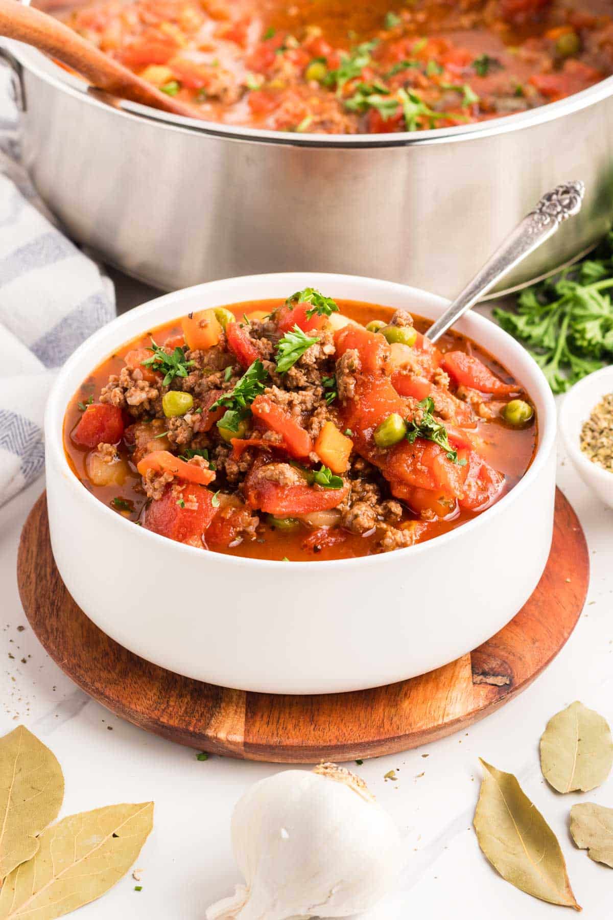 A white bowl filled with hamburger vegetable soup.