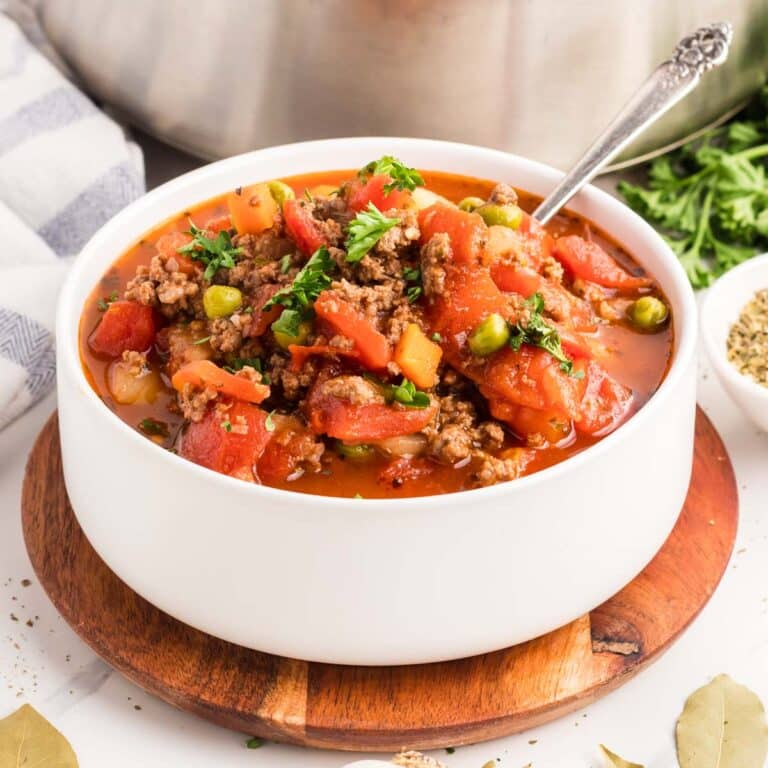 A white bowl filled with hamburger vegetable soup.