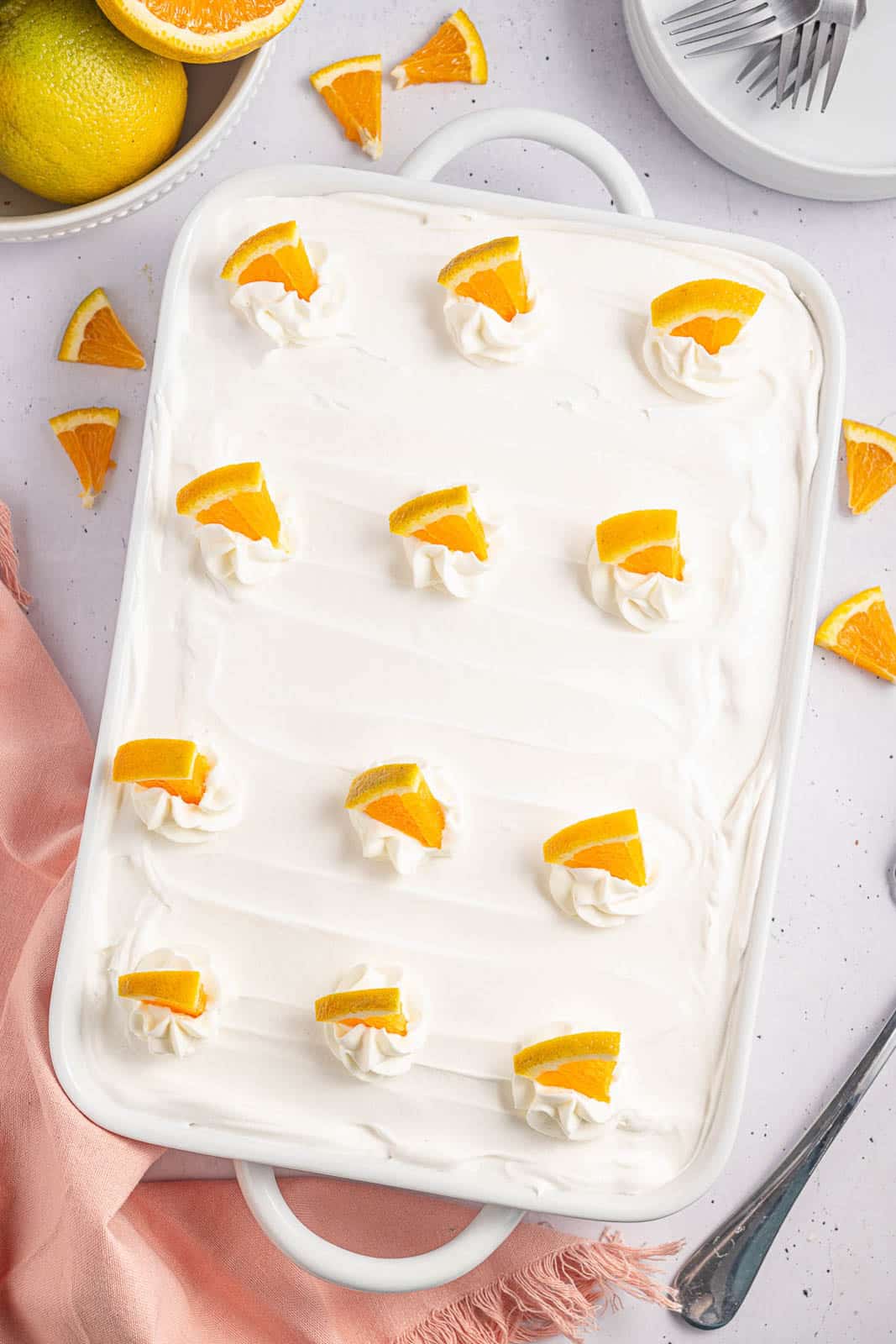 A white 9 x 13 casserole pan filled with orange Creamsicle bar dessert.