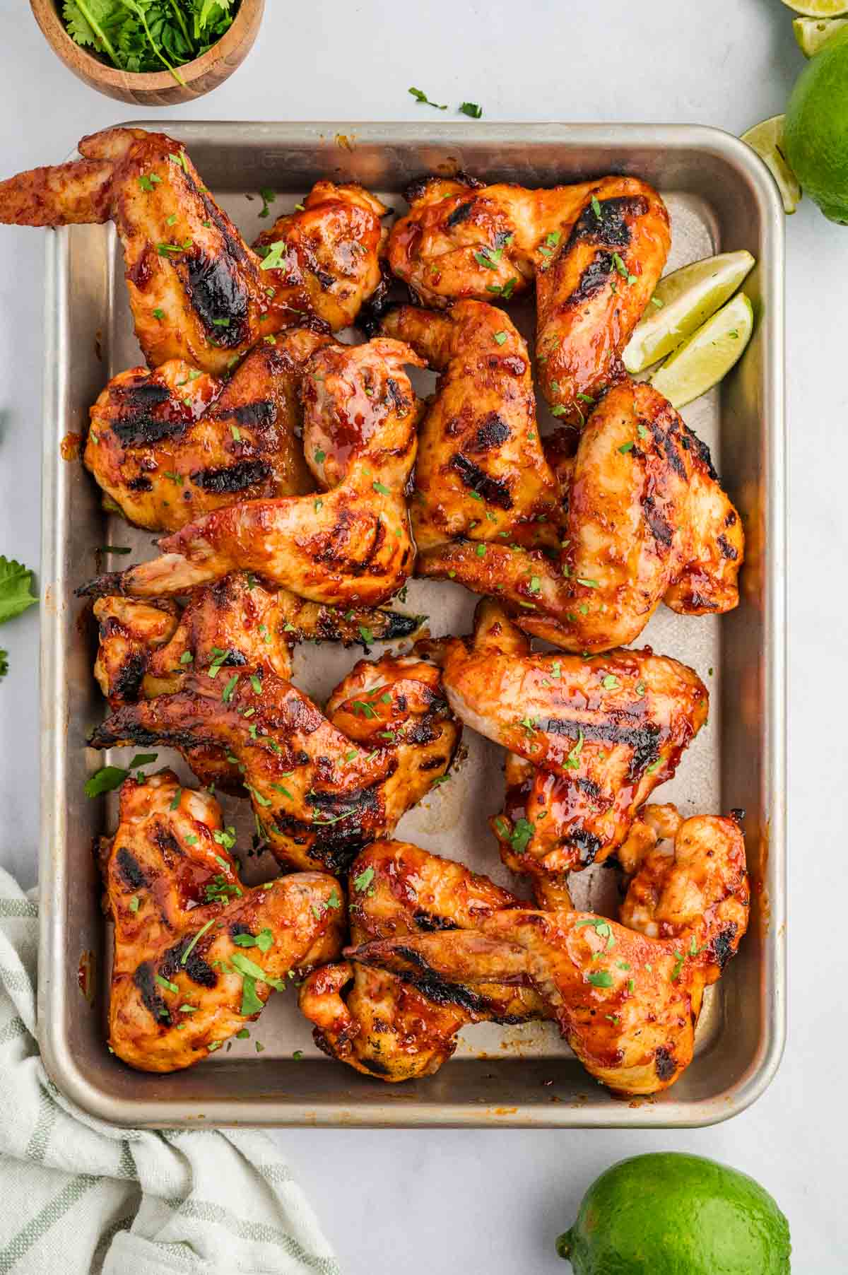 A baking sheet with chicken smothered in sweet & spicy chipotle bbq sauce.