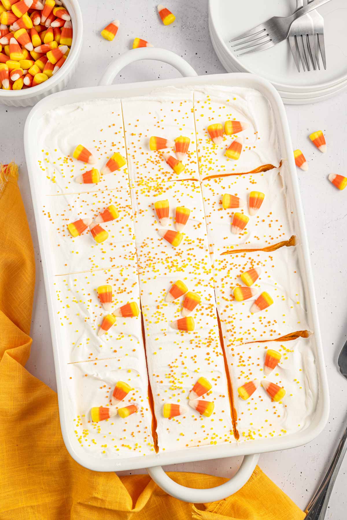 Overhead shot of candy corn lush in a white baking dish sliced into squares.