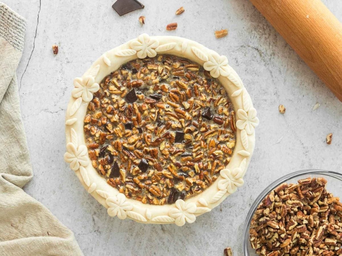 Chocolate pecan pie filling added to pie dough.