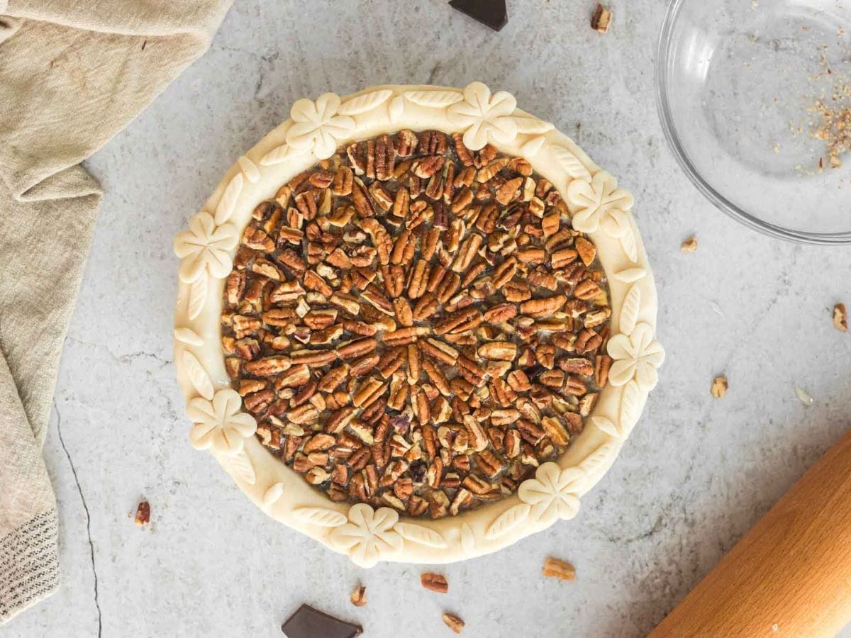 Pecans laid on top of pie filling in a circular pattern.