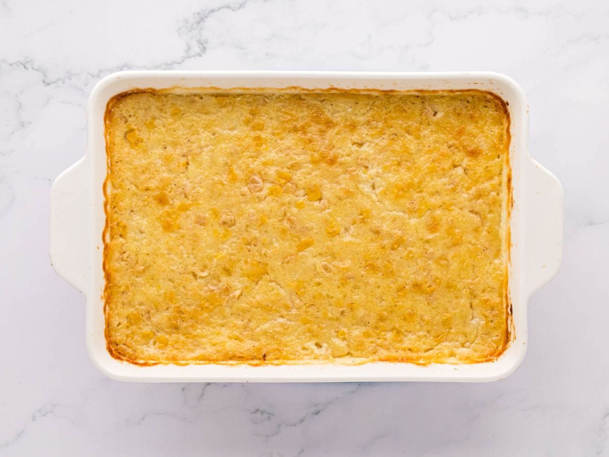 Baked Corn Pudding in a white ceramic baking dish.