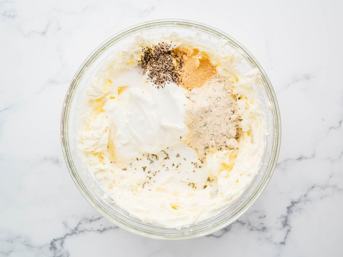 Crack chicken cream cheese mixture being combined in a mixing bowl.