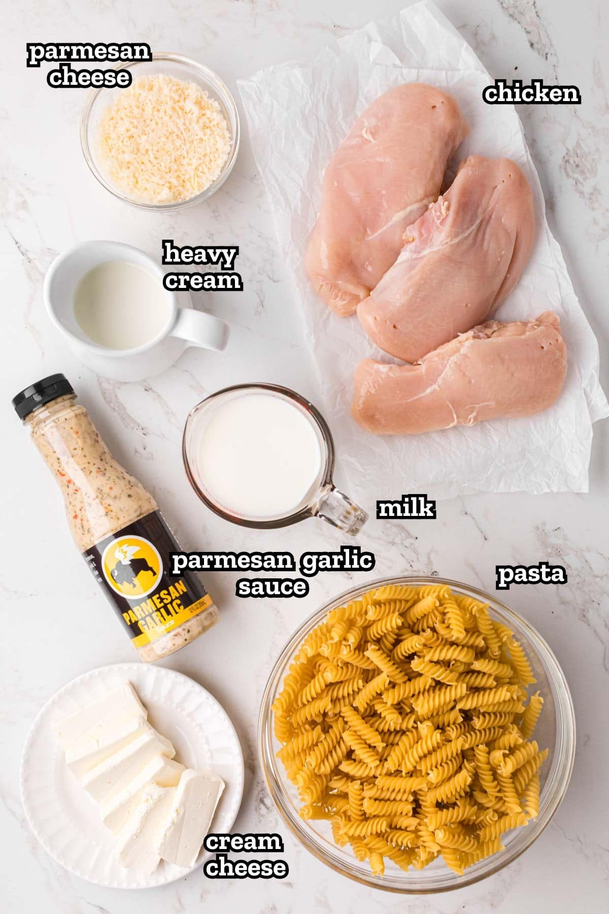 Labeled ingredients needed to make garlic Parmesan chicken pasta in the slow cooker.