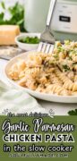 Pinterest image showing the slow cooker in the background and a plate of garlic parmesan chicken with a fork removing a bite.