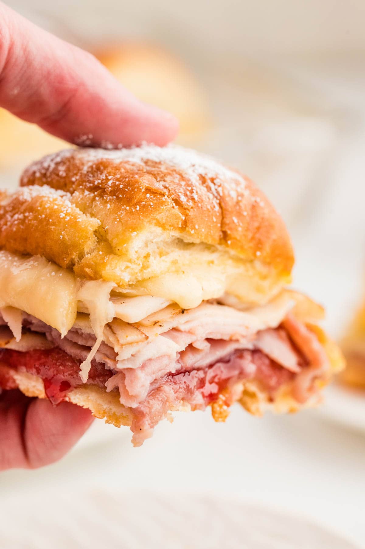 Hand holding a monte cristo slider.