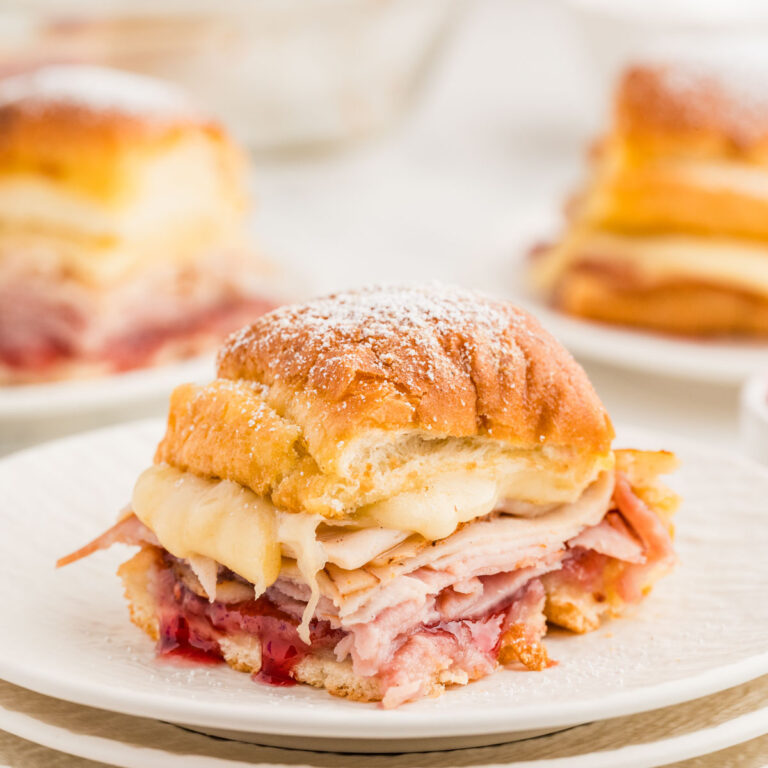 Side view of a monte cristo slider served on a plate.