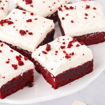 A serving plate of sliced thread velvet brownies.