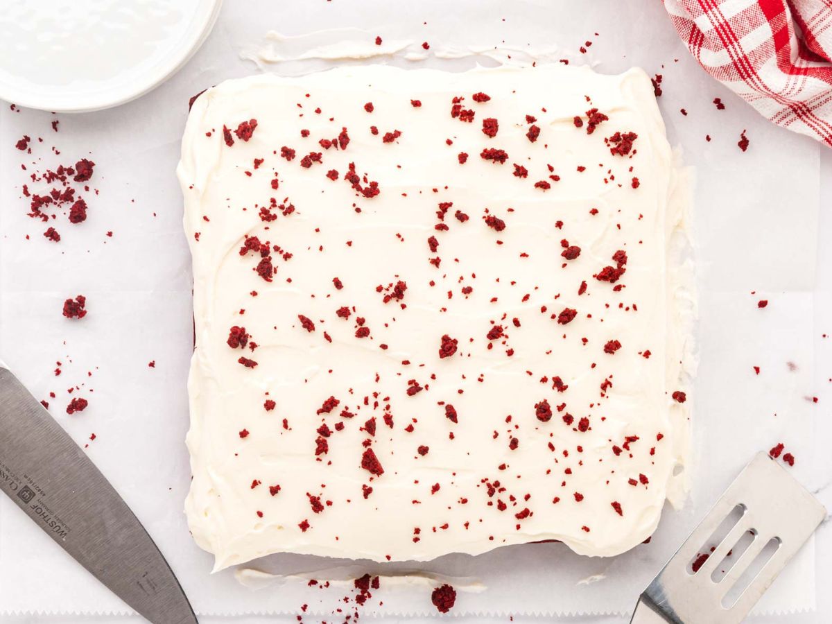 An overhead image of cream cheese frosted red velvet brownies.