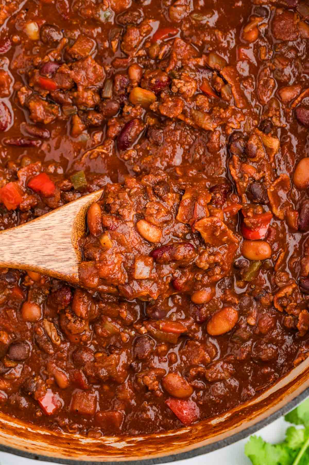 Wooden spoon in a pot of smoked chili.