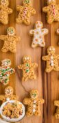 Holiday Gingerbread Rice Krispie treats are featured on a wooden cutting board with icing decorations.