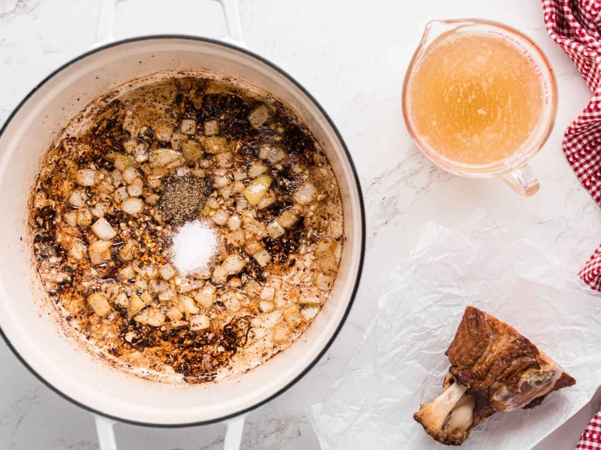 Seasonings added into salt, onions, and garlic, and a white pot.