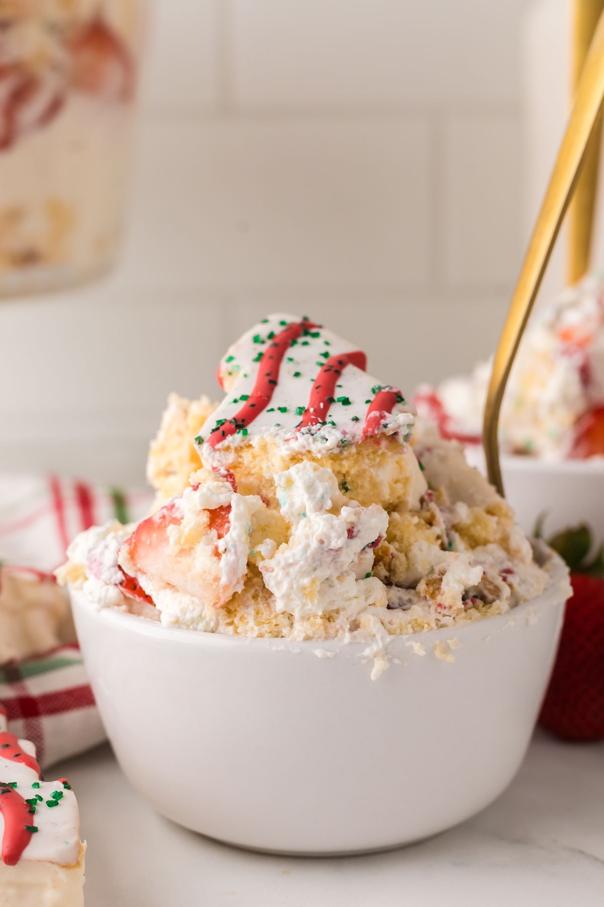 A spoon, taking a bite of the little Debbie Christmas tree dessert.