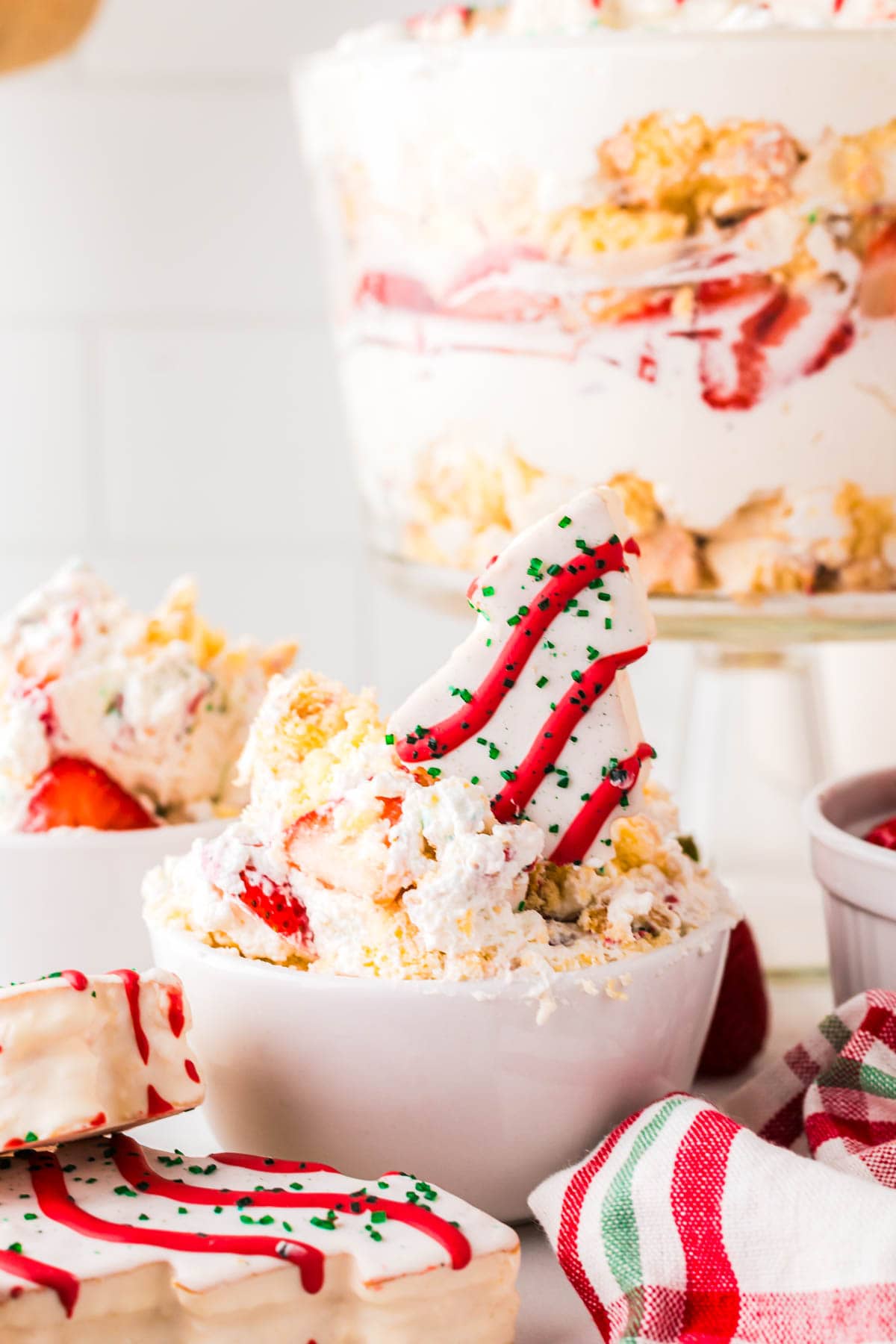 A serving bowl filled with a scoop of the little debbie christmas tree trifle dessert.