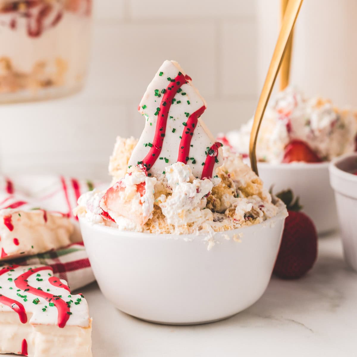 A spoon, taking a bite of the little Debbie Christmas tree dessert.