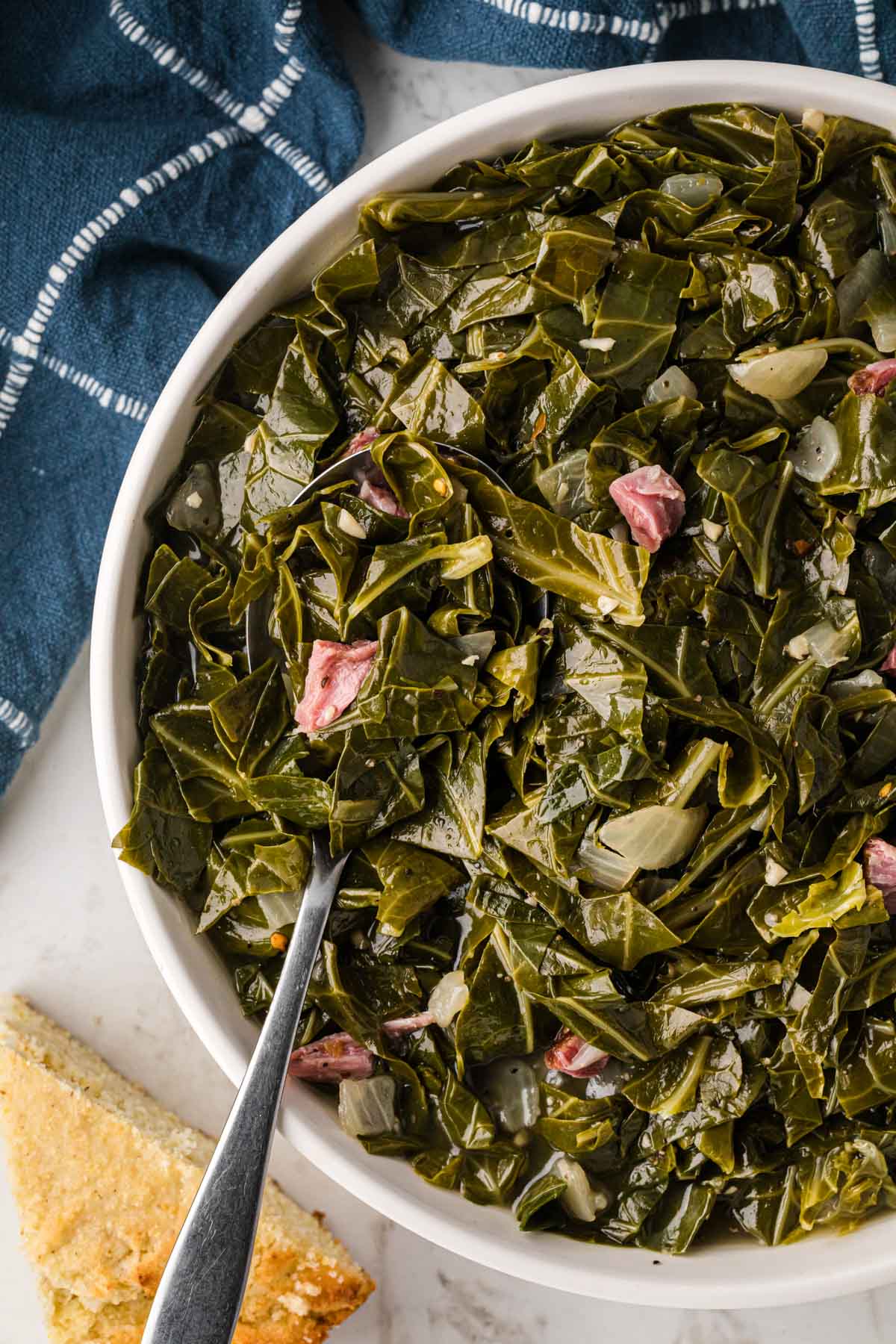 Overhead image of a bowl of southern style collard greens with ham pieces.