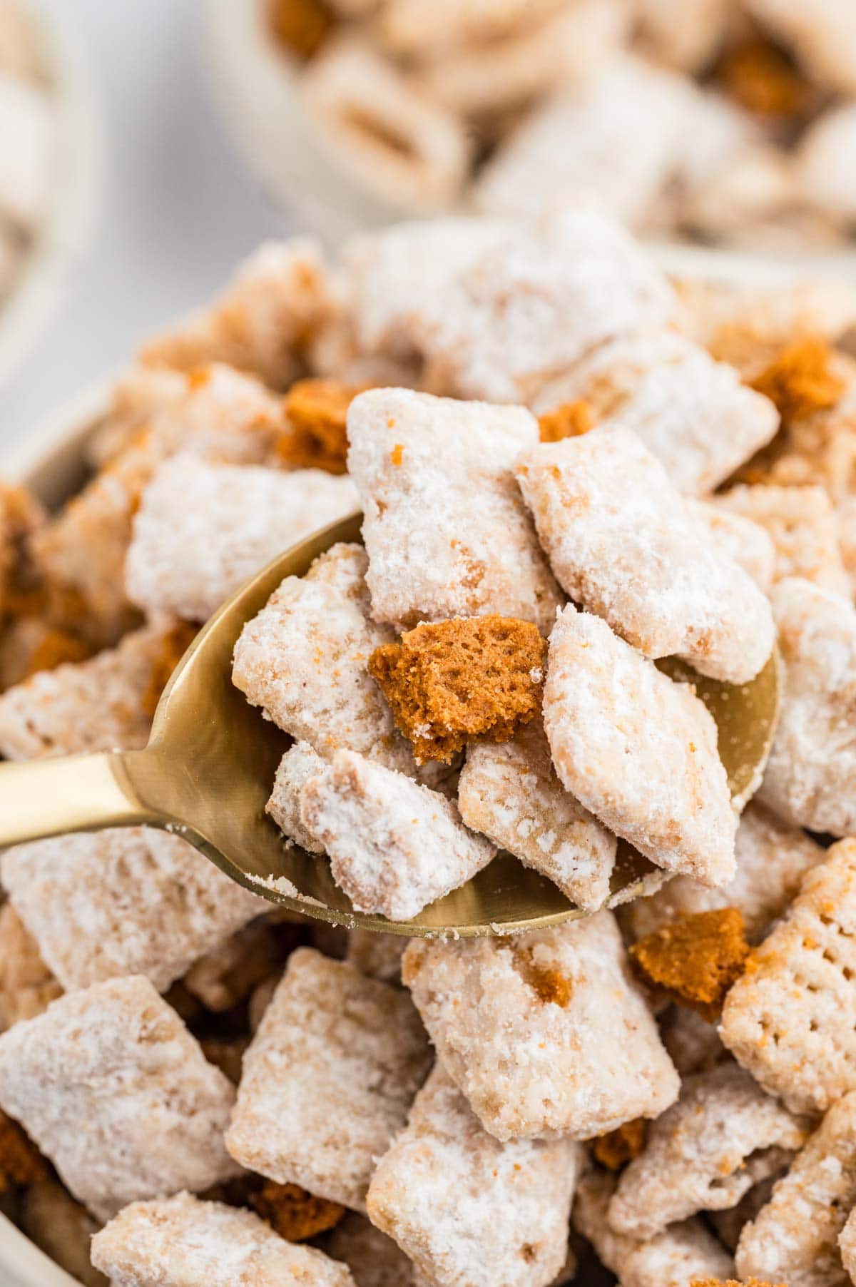 Spoon scooping up some muddy buddies from a bowl.