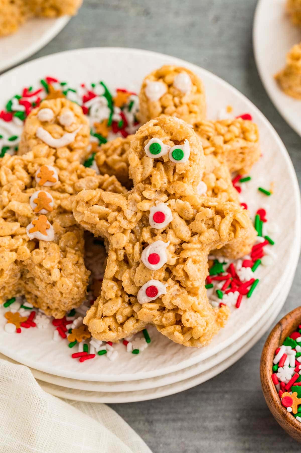 Gingerbread rice Krispie treats served on a plate with sprinkles.