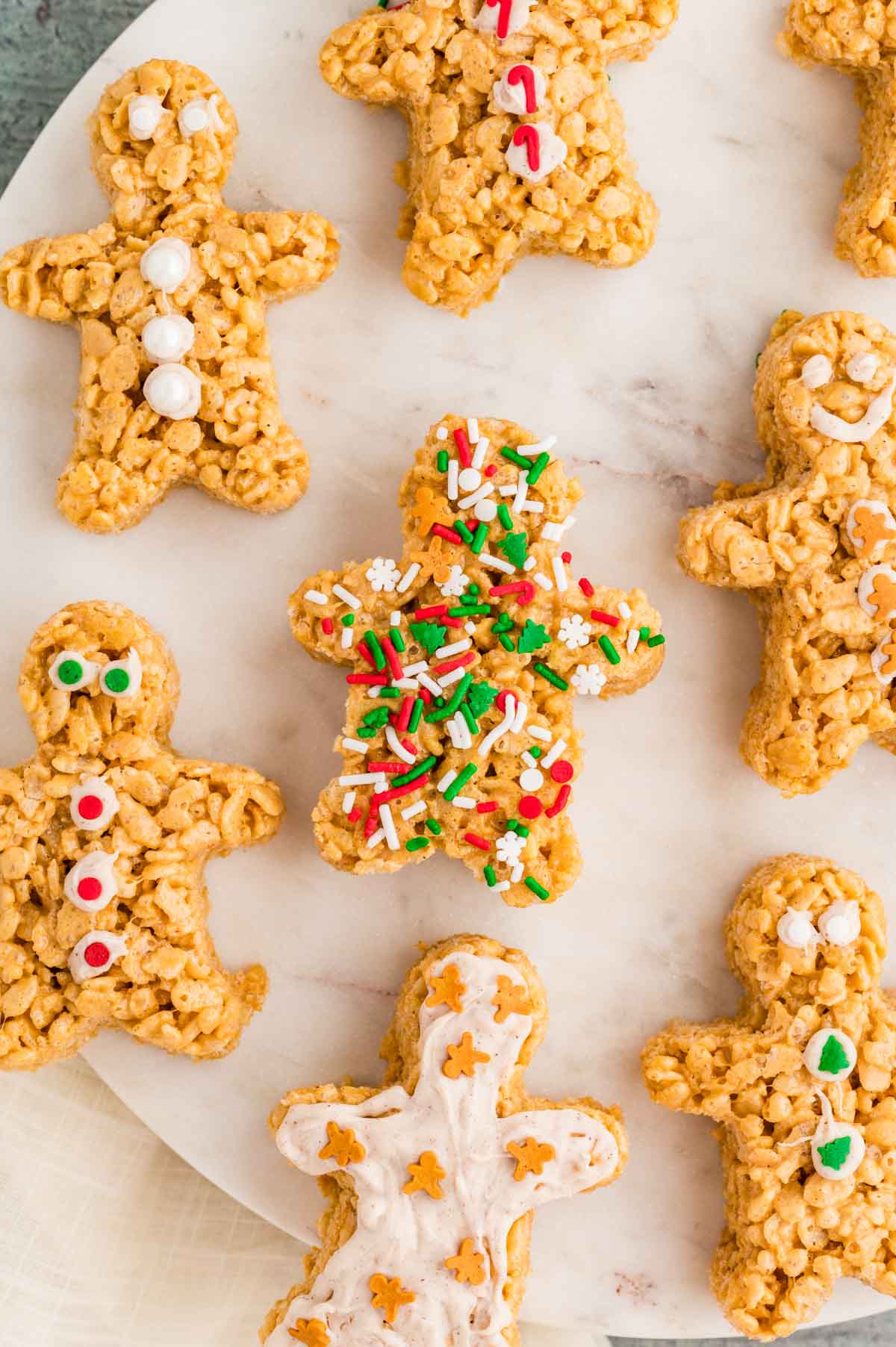 Overhead shot of gingerbread rice krispie treats decorated with white chocolate and sprinkles.