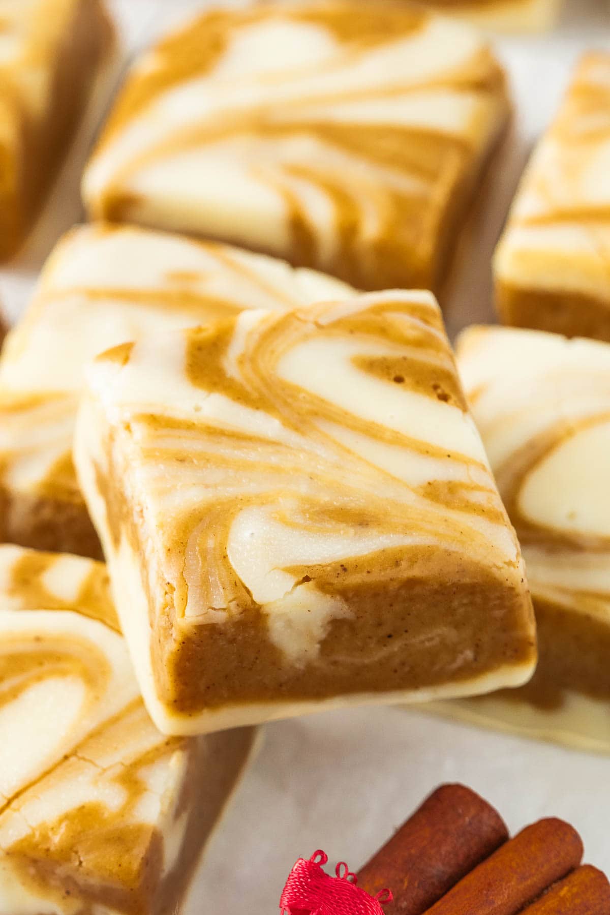 Squares of gingerbread swirl fudge with one on top of the others.