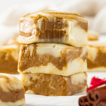 Stack of gingerbread swirl fudge pieces with one missing a bite.