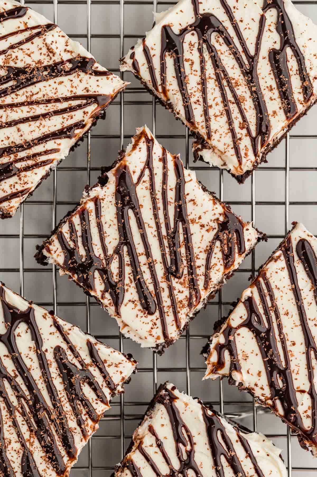 Overhead shot of hot chocolate brownies with chocolate drizzled on top on a wire rack.