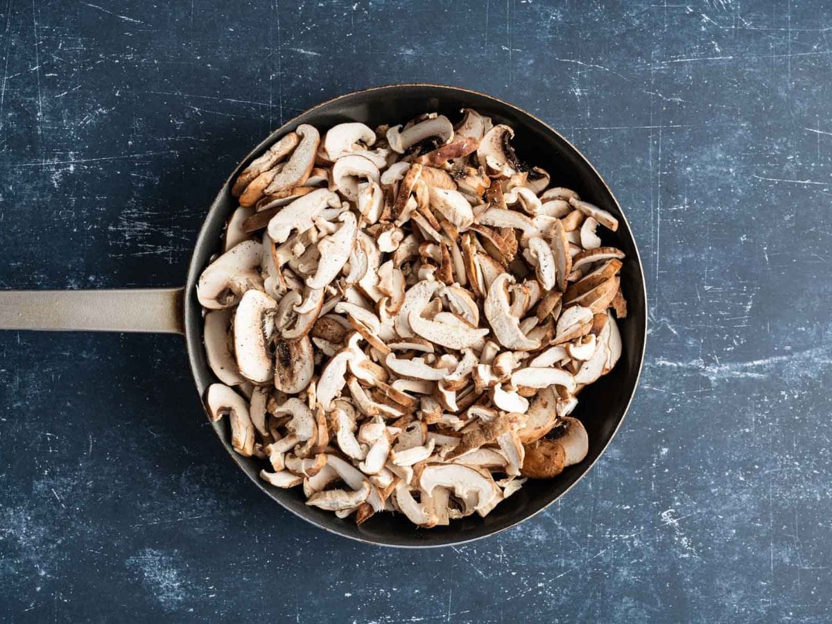 Mushrooms being cooked in a skillet.