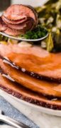 Honey Baked Ham Recipe image with the glaze dripping down the partially sliced ham image only.