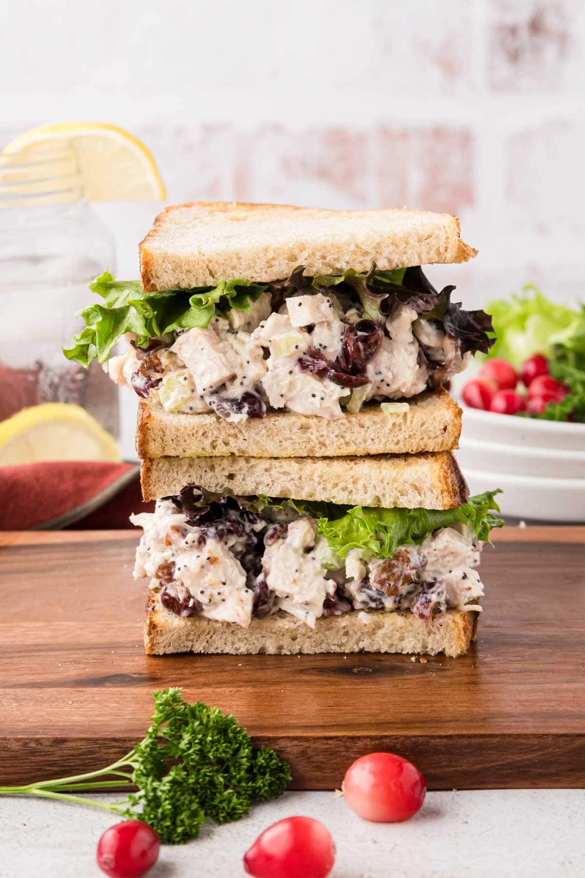 A turkey salad sandwich on italian bread cut in half and stacked on top of each other.