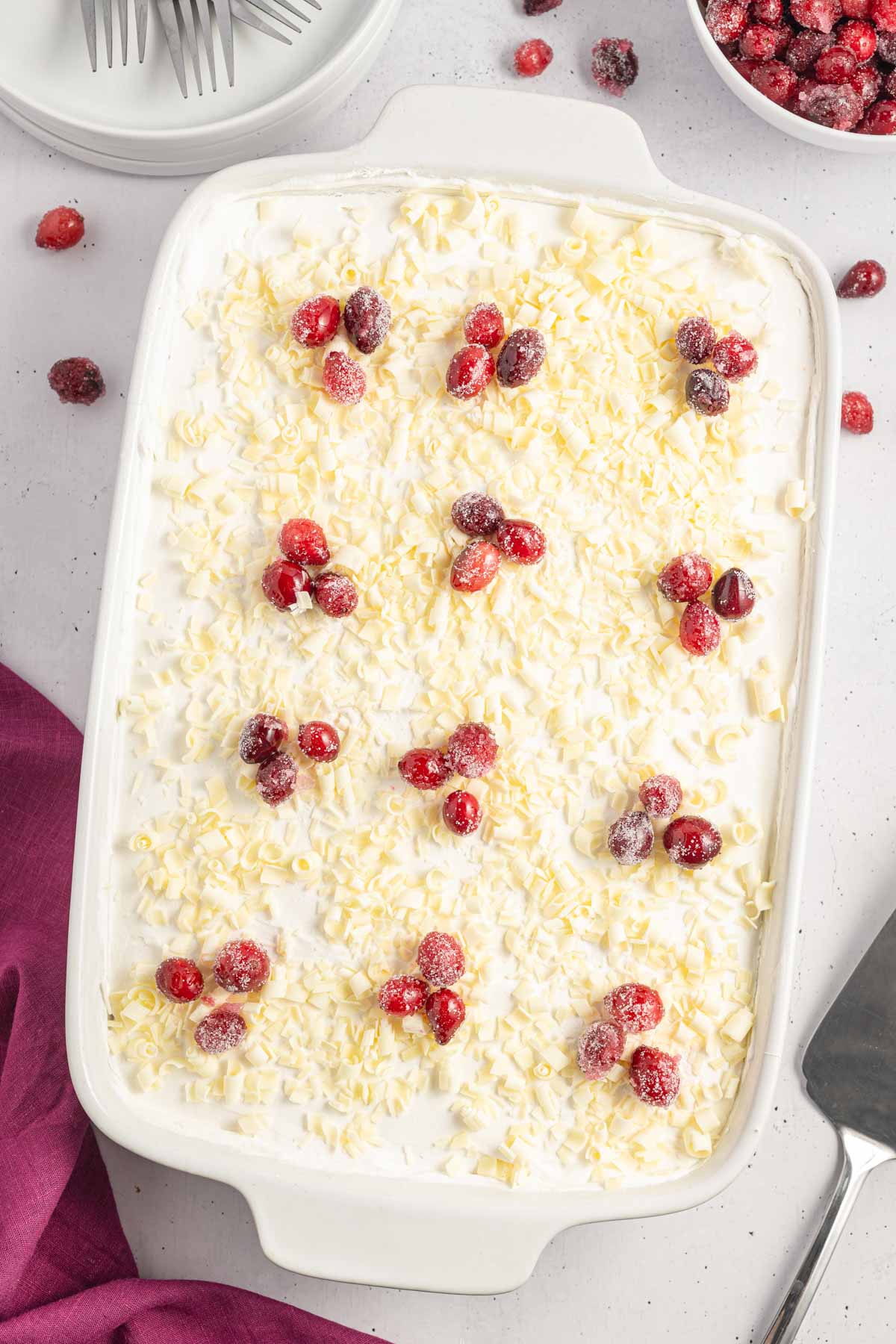 Overhead shot of the white chocolate cranberry dessert in a baking dish garnished with cranberries.