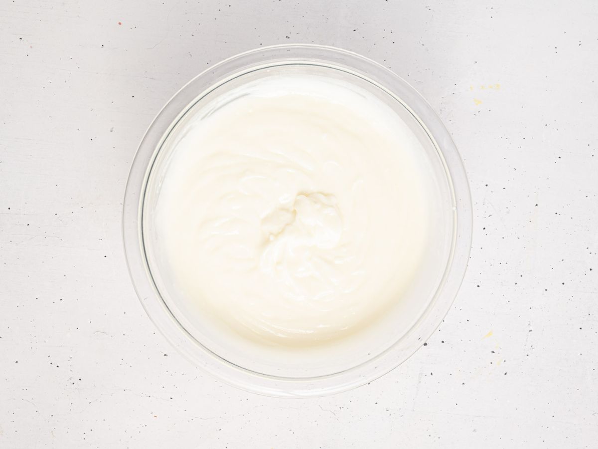 White chocolate pudding in a glass mixing bowl.