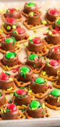 Square pretzels with Rolos and Candies are on a tray and made in red and green for Christmas in this 2 image collage.