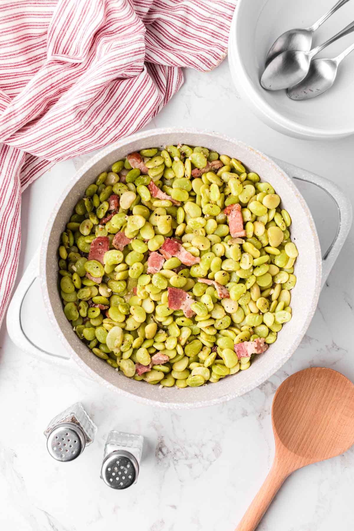 A pot of baby green lima beans cooked with bacon.