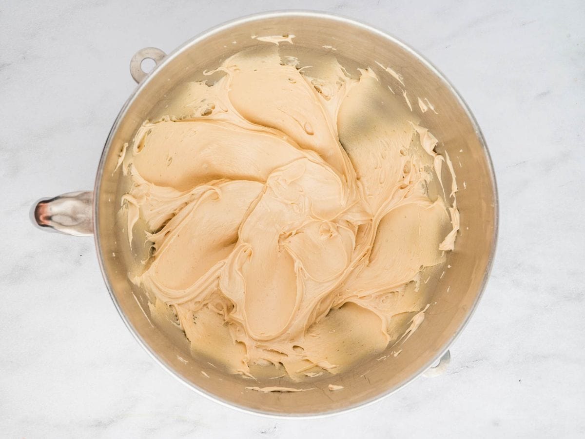 Overhead shot of the cookie butter frosting in the mixing bowl of a stand mixer.