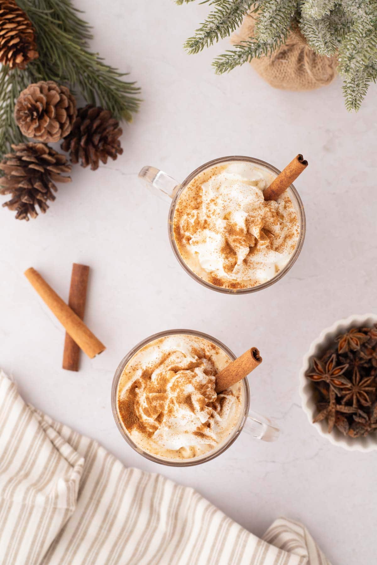 To eggnog latte with whipped cream, sprayed on top dusted with cinnamon and a cinnamon stick added.