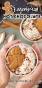 Gingerbread Hot Chocolate image in a Christmas mug with a gingerbread man cookie on top.