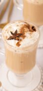 Image only for Eggnog Latte is pictured here in two glass much topped with garnishes and with a tan and white tea towel.