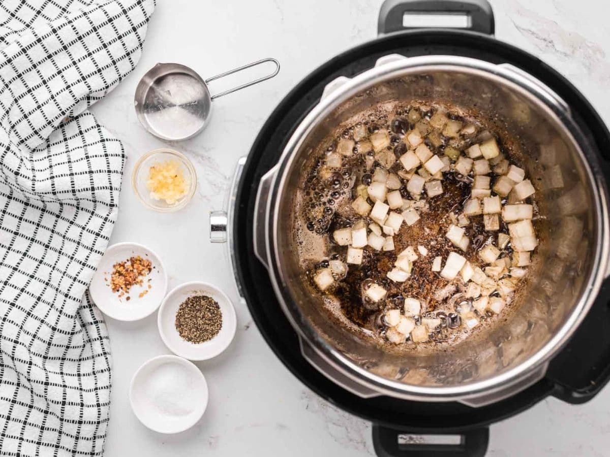 Onion added into the Instant pot to sauté.