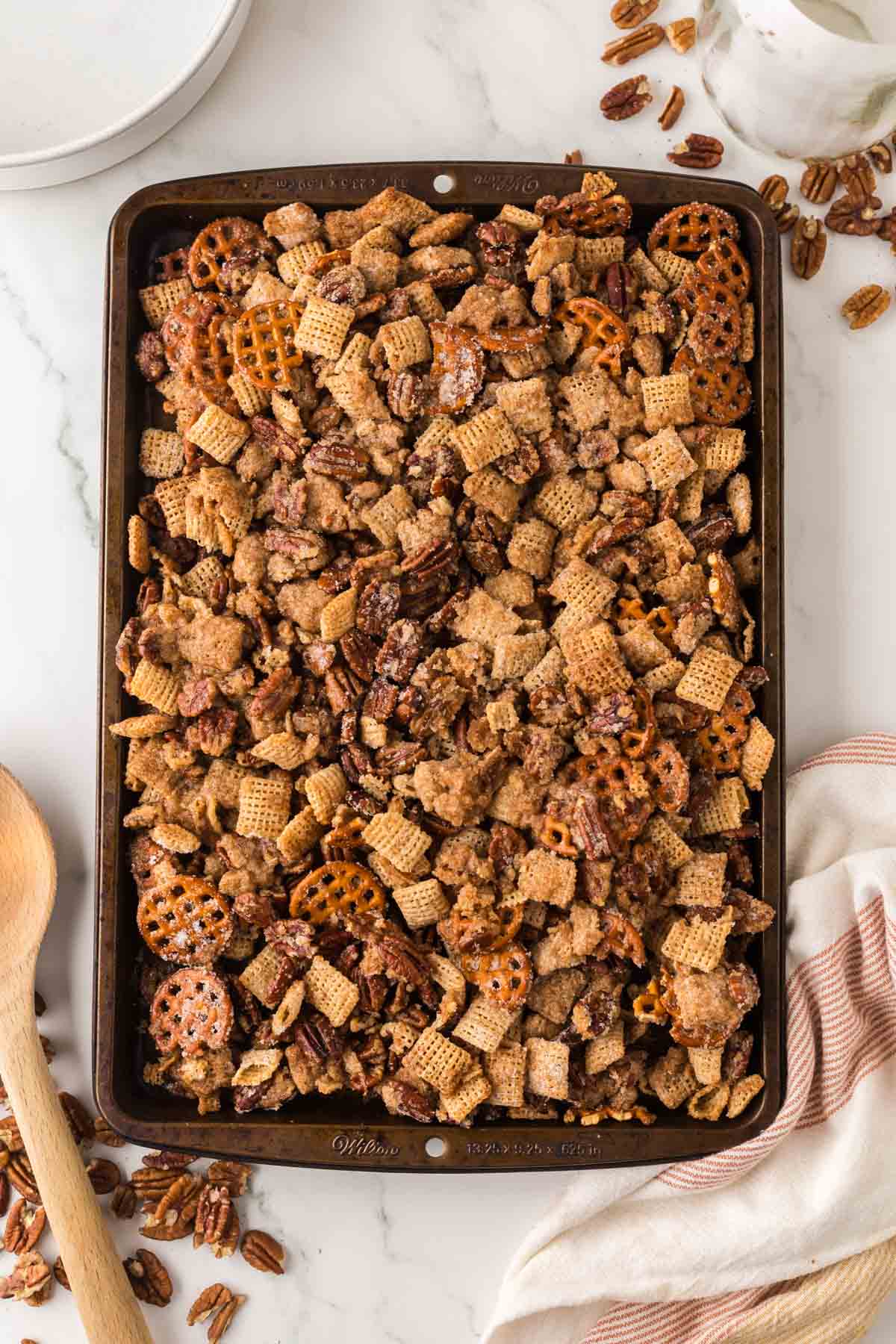 Overhead shot of praline snack mix on a sheet pan.